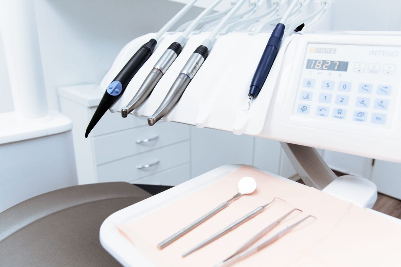 Dental handpieces and a tray of clean instruments, ready for treatment